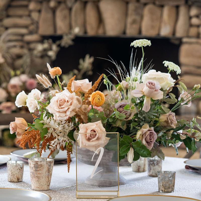 A beautifully arranged table with flowers and candles, creating an elegant and romantic ambiance